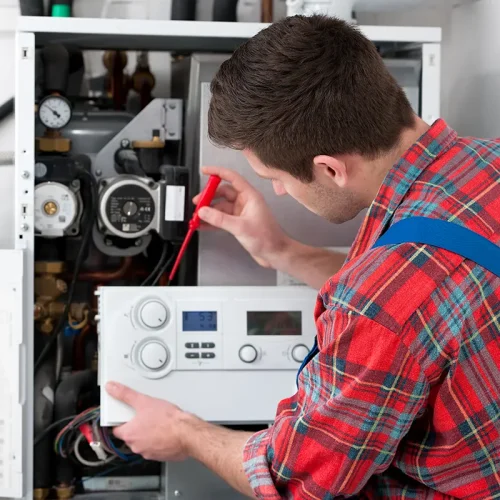 man inspecting the boiler