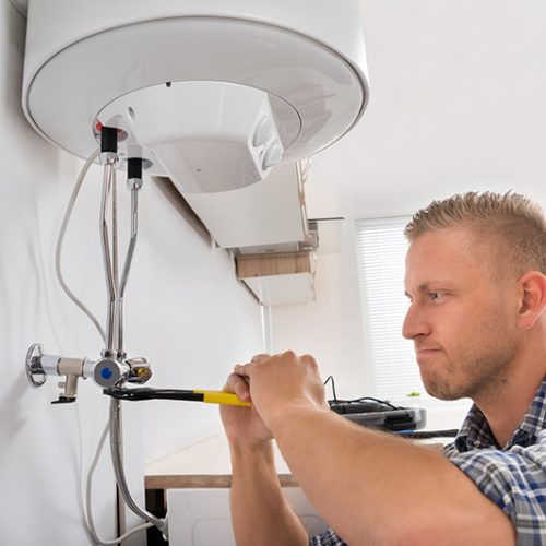 man fixing the boiler