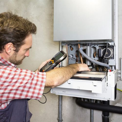 man checking the boiler