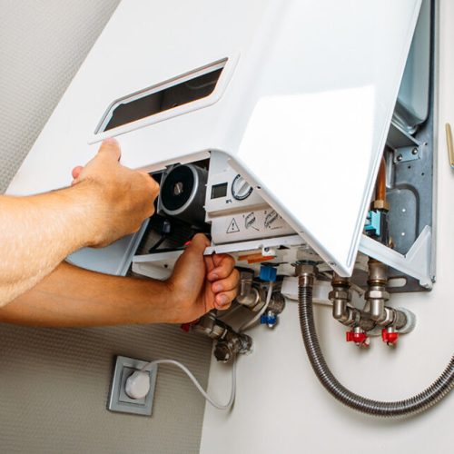 man checking the boiler