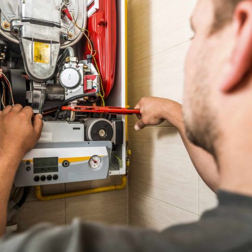 man fixing the boiler