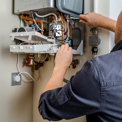 man fixing the boiler