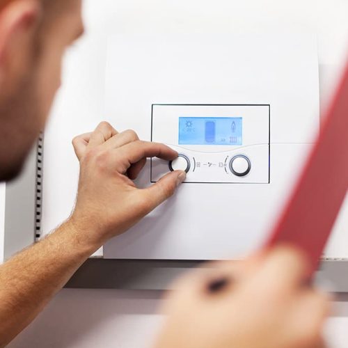 man checking the boiler