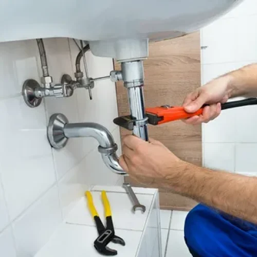 man fixing pipe